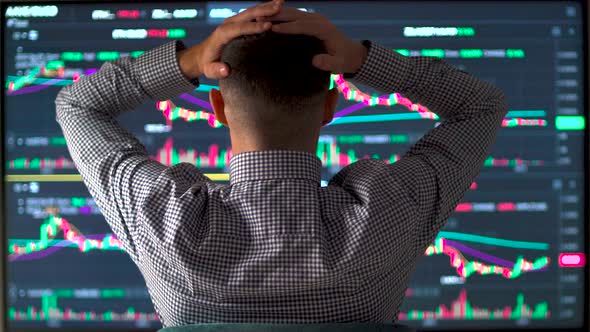 Stressed Businessman Holding Hands on Head While Stock Market Value Decrease