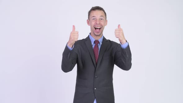 Studio Shot of Happy Businessman Looking Excited While Giving Thumbs Up