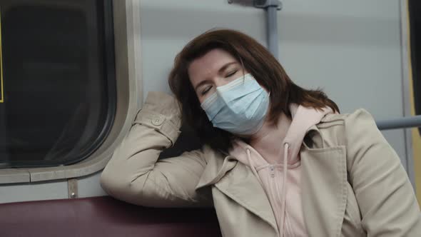 Woman in Mask Sleeping in Subway Train