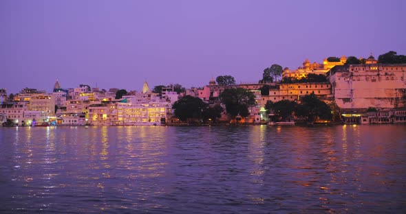 Udaipur Lal Ghat Houses and City Palace on Bank of Lake Pichola with Water Riffles Rajput