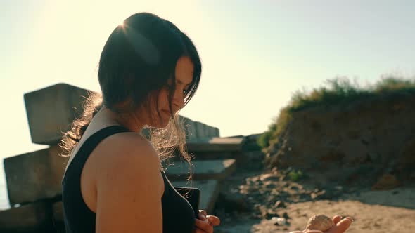 Portrait of a Girl on the Beach Listening to a Shell By the Sea