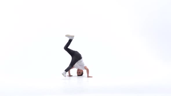 Little Boy Is Dancing a Modern Dance on the White Background in Black Leather Jackets and Jeans