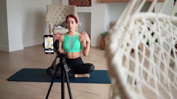 Online Learning and Live Streaming Woman Blogger Fitness Filming on Phone Camera