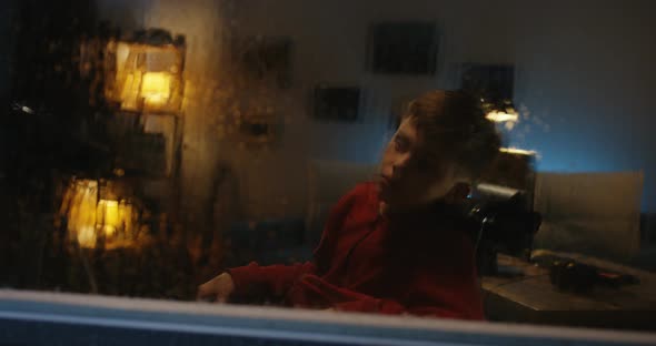 Wheelchaired Boy Watching Storm From Room