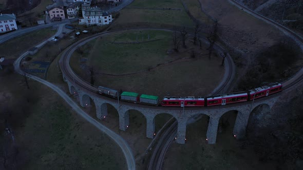 Train on Brusio Spiral Viaduct in Switzerland at Night