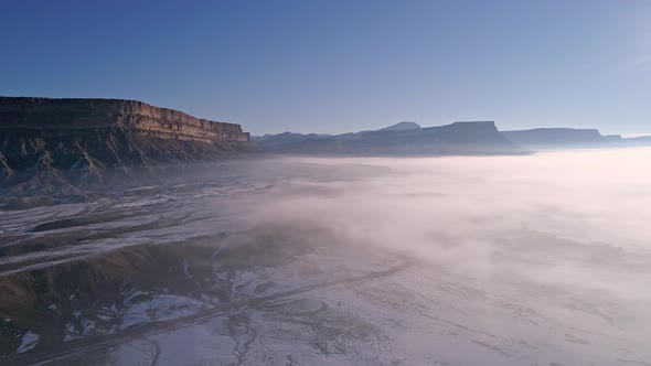 Aerial view of blue sky over foggy desert landscape