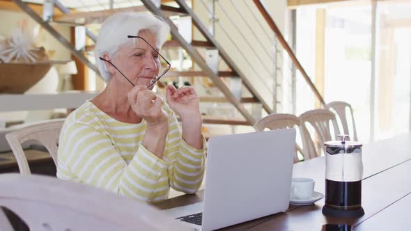 Senior caucasian woman using laptop in the living room at home