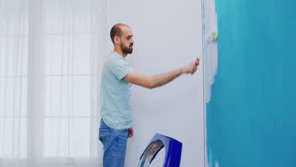 Applying White Paint on Wall