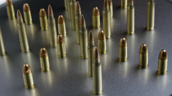 Cinematic rotating shot of bullets on a metallic surface - BULLETS