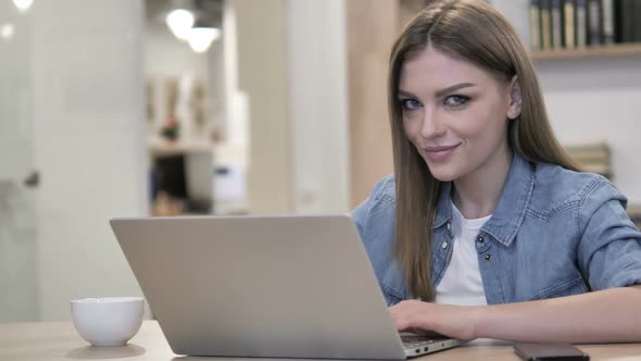 Happy Creative Young Girl Winking Eye While Looking at Camera