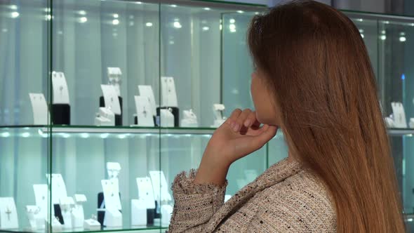 Young Female Customer Smiling, Choosing Jewels for Sale at the Luxury Store 1080p