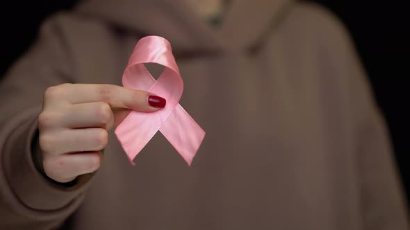 Hands Holding Breast Cancer Ribbon