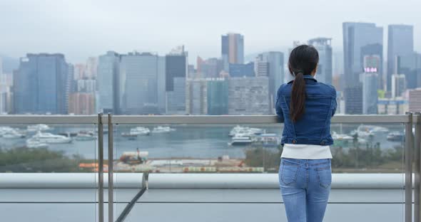 Woman look at the city view in Hong kong