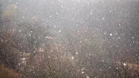 Falling upwards snowflakes during winter snowfall. Abstraction. Slow motion.