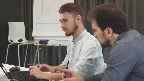 Creative Team of Designers Working Together on the Computer