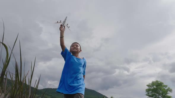 Asian Boy Running With A Airplane Toy