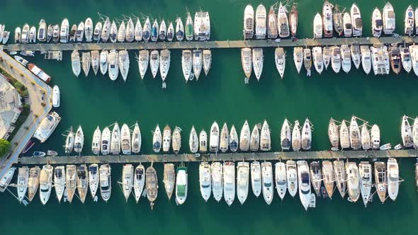 aerial top down view of sailboats docked in the Bodrum marina with turquoise green water on a summer