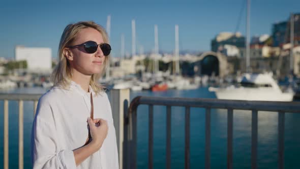 An Attractive Young Woman in a White Dress is Spending Her Vacation in Europe