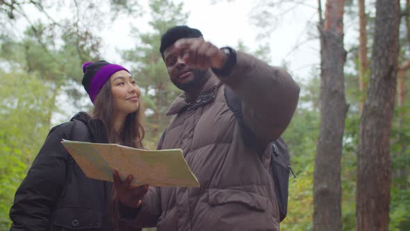 Multiracial Tourists on Trek Navigating with Map