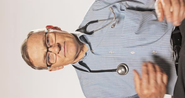 Mature Older Doctor Dressed in Shirt and Glasses Prepares to Receive Patients Conducts Interview