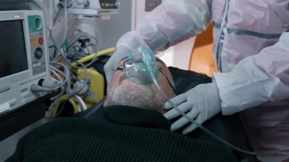 Paramedics Putting Oxygen Mask on Patient with COVID 19