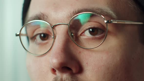 Closeup Face of Young Man with Mustache Taking Off Glasses Hat