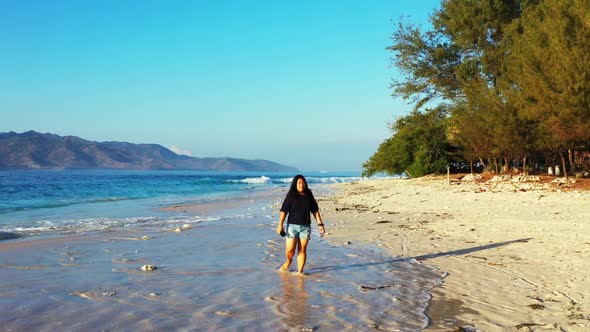 One woman sunbathing on beautiful sea view beach time by shallow lagoon with white sandy background 