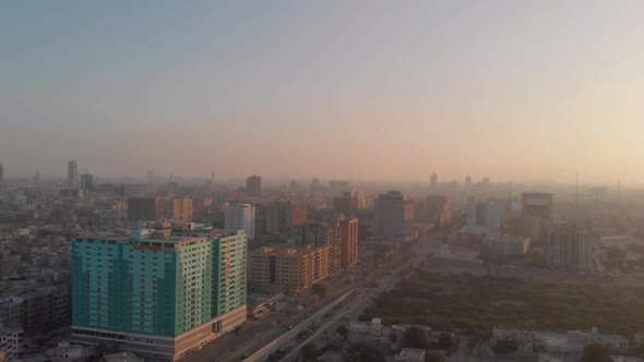 Aerial View Of Golden Yellow Sunset Over Karachi City In Pakistan. Slow Dolly Back