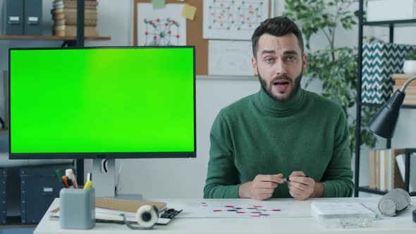 Online School Teacher Pointing at Chroma Key Green Computer Screen Speaking During Remote Lesson alt