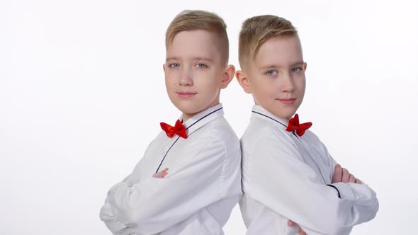 Caucasian Identical Twins Posing in Studio
