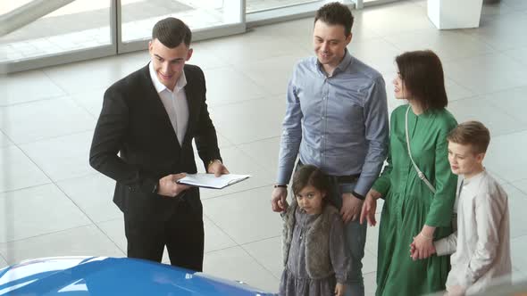 Mother Father and Child Buying Car at Dealership a New Family Auto