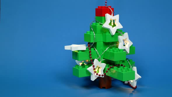 Christmas tree made of the toy blocks. Quirky and unusual New Year tree