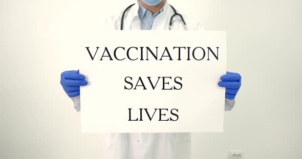 Male Doctor Holding Banner Vaccination Saves Lifes