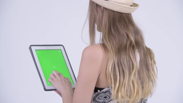 Closeup Rear View of Blonde Tourist Woman Using Digital Tablet