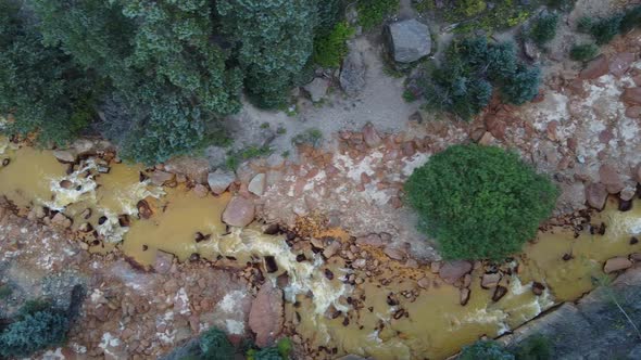 Aerial Looking Down Over Rapids River with Large Red Boulders