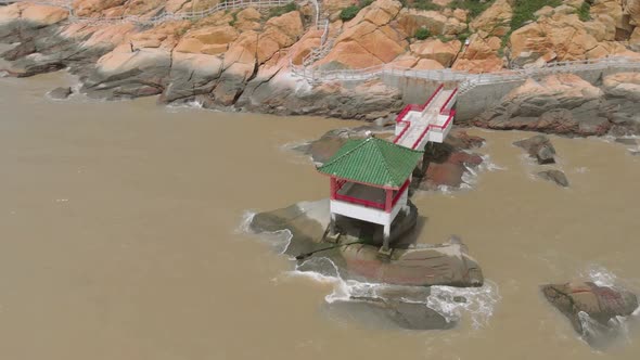 Aerial orbit shot of traditional Chinese pavilion on the coast of Coloane, Macau