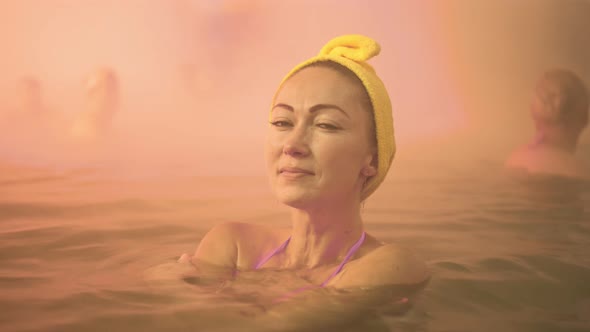 Close Up Caucasian Woman in a Swim in Hot Saline Mineral Water Bath at a Traditional Spa Outdoor