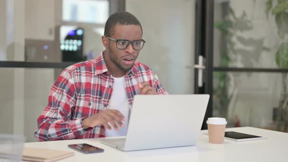 African Man Feeling Shocked While Using Laptop