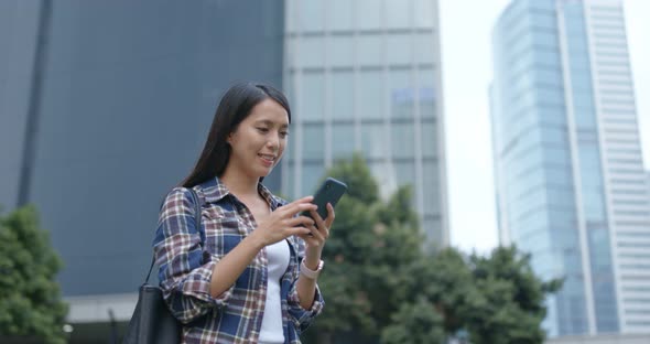 Woman look at mobile phone in city