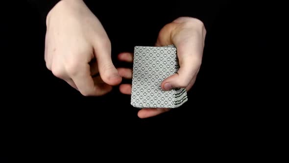 Playing Cards Being Spread, Changing the Card, on a Black Surface By Magician