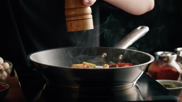 Chef Frying Vegetables in Pan Closeup