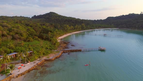 Flying on Koh Kut over Wooden peer on the Beach