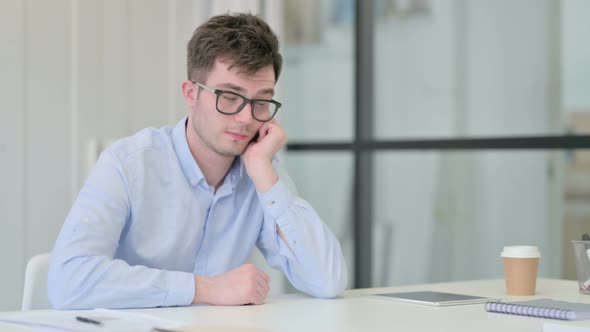 Young Man Taking Nap in Office