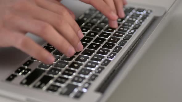 Close Up of Fingers Typing on Laptop