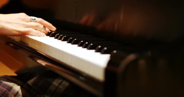 Close-up of woman playing a piano