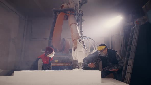 Colleagues Watching Milling Machine Cutting Plastic