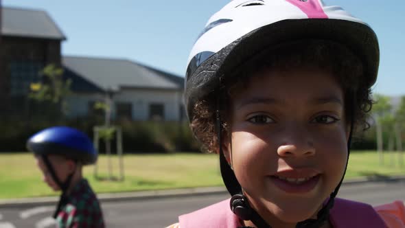 Girl wearing helmet smiling on the road