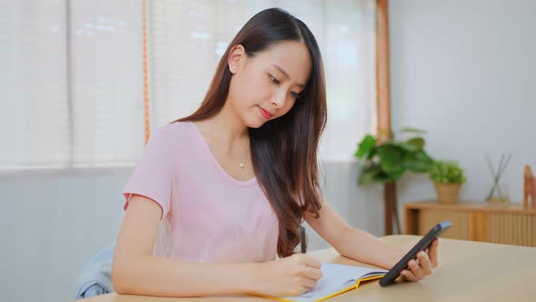 Homeschool Asian attractive young girl student distance learn virtual internet online class at home.