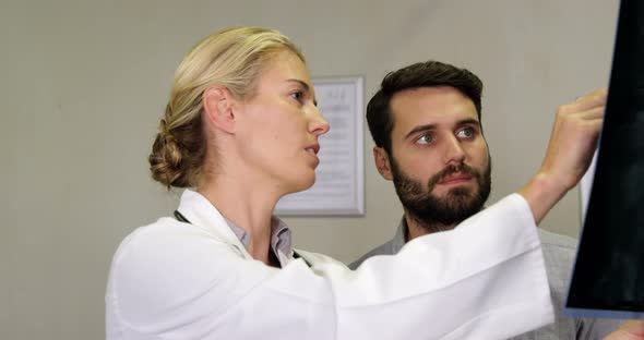 Physiotherapist explaining x-ray to patient