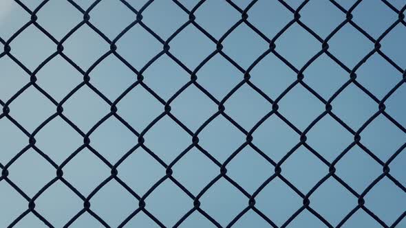 Moving Past Fence Against Blue Sky